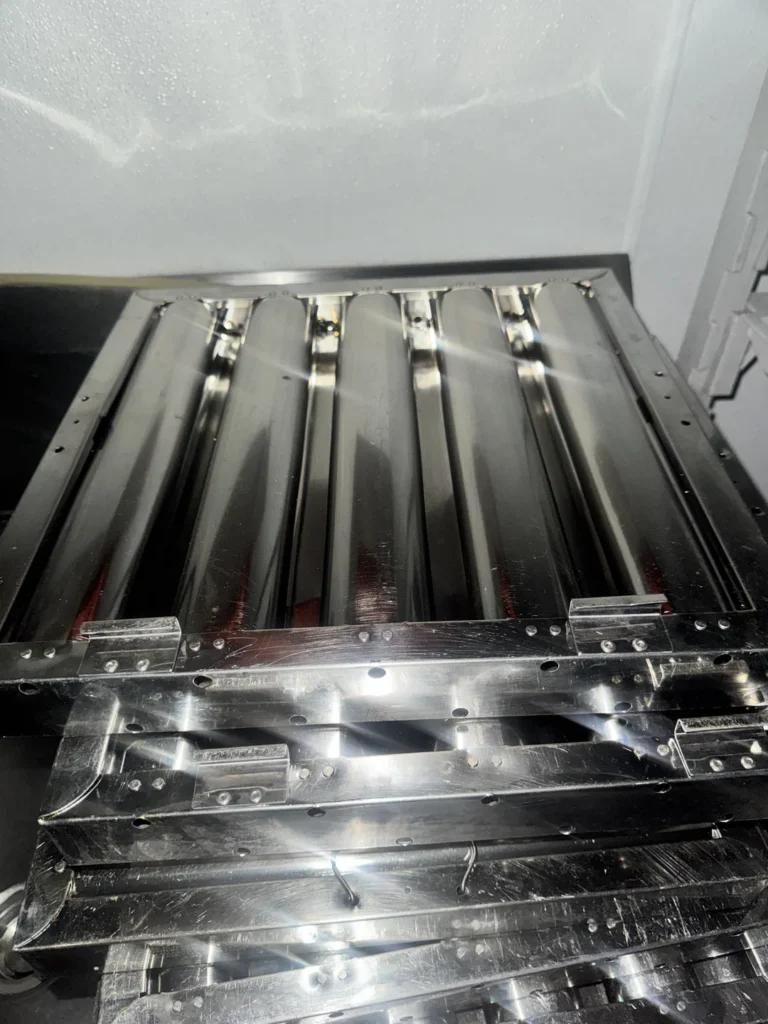 Clean stainless steel baffle filters removed from a kitchen hood