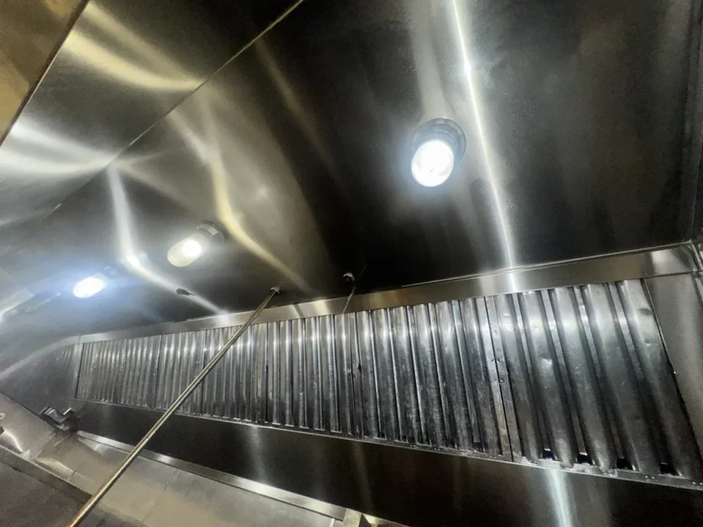 Commercial kitchen hood canopy after cleaning with the baffle filters reinstalled