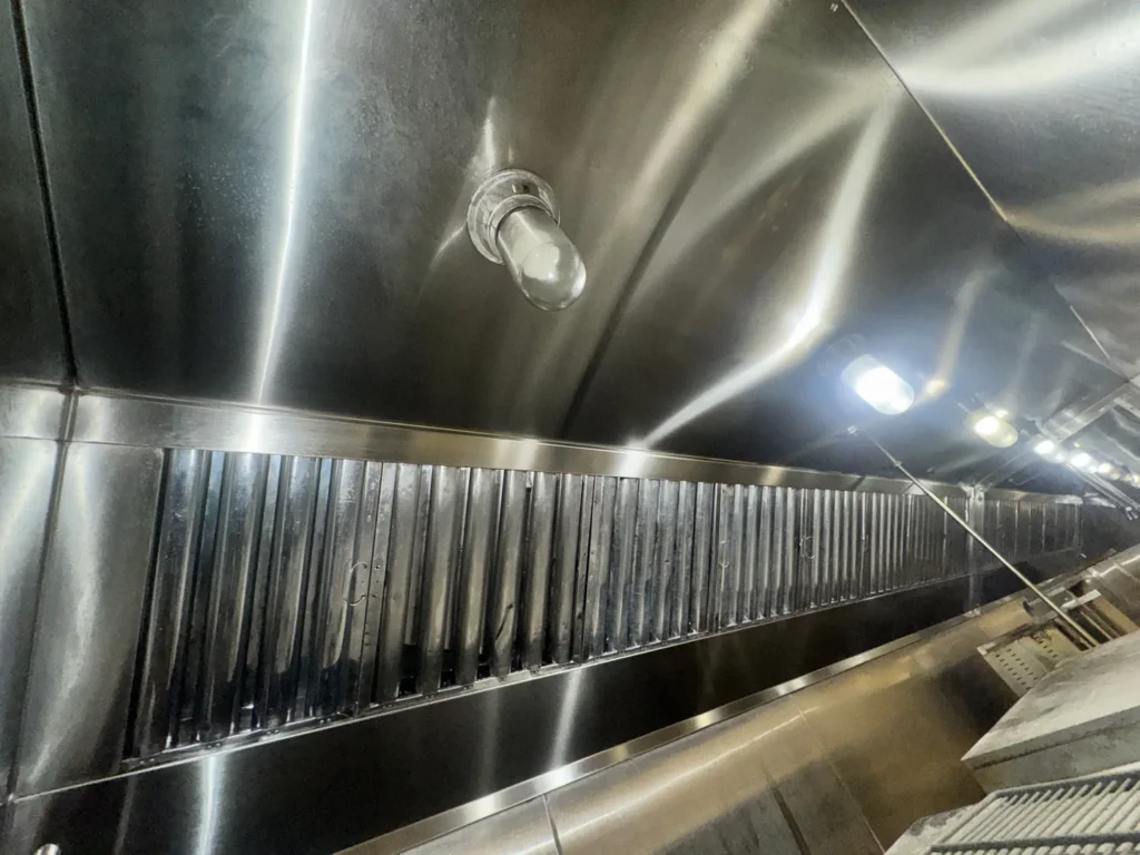 Commercial kitchen exhaust hood with baffle filters installed